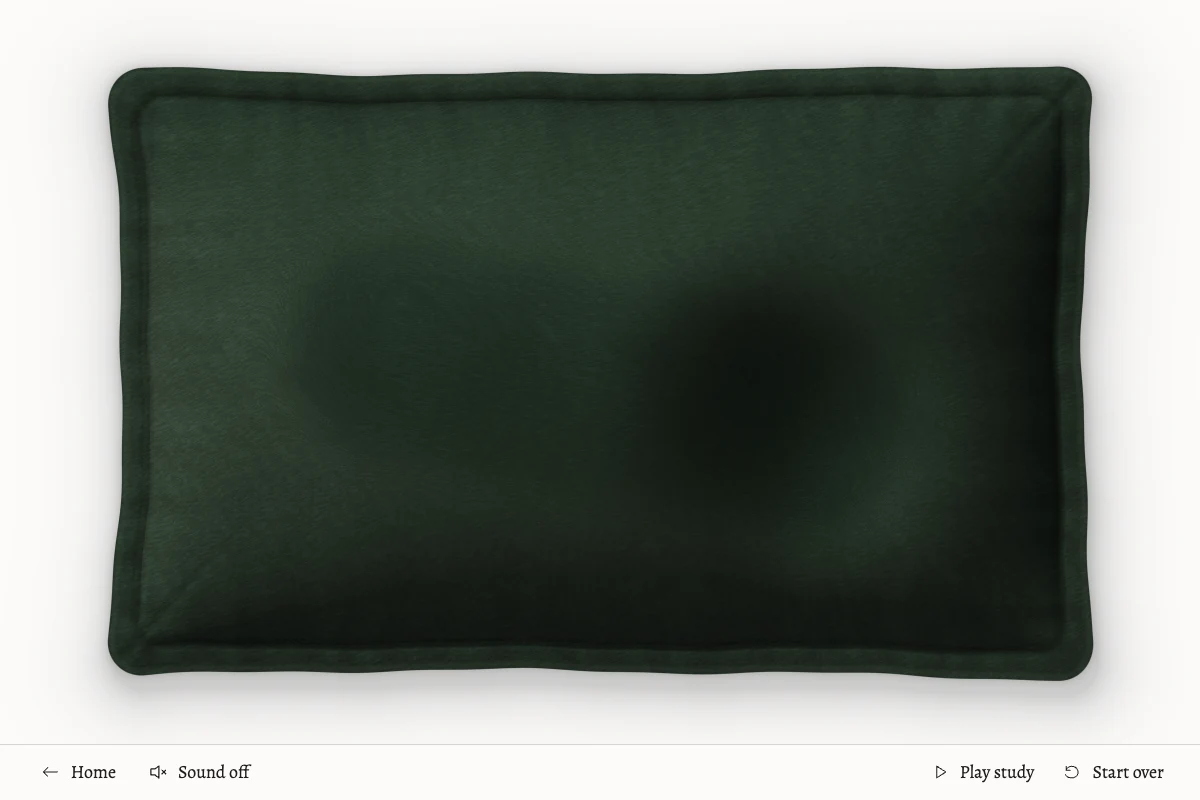 A green velvet pillow with soft traces left by stroking its digital surface